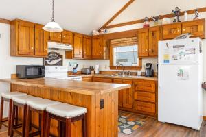 a kitchen with wooden cabinets and a white refrigerator at 7097 - Kickin` Back in Nags Head