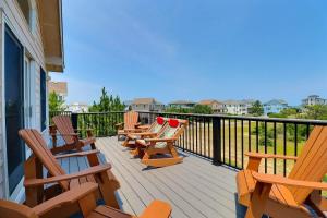 a row of chairs sitting on a balcony at 1700 - Carolina Delight in Poplar Branch