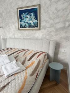 a bedroom with a bed and a picture on the wall at Grand Lake View Apartment in Ohrid +23 photos
