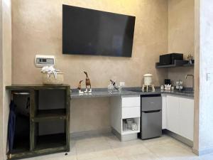 a kitchen with a counter with a television on the wall at Acogedor espacio LAppuntamento in Santeagueda +10 photos