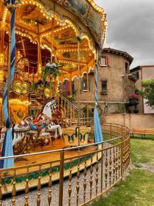 a carousel with horses on it in a park at Acogedor espacio LAppuntamento in Santeagueda