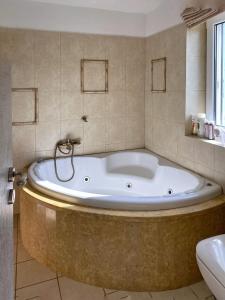 a large bath tub in a bathroom with a sink at Hébergement cycladique - près de Panormos in Mykonos +20 photos