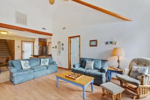 a living room with two blue couches and a table at 1714 - Destiny in Poplar Branch