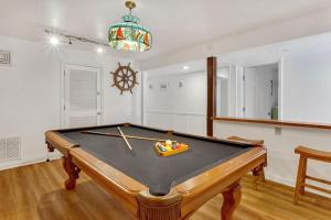 a pool table in a room with a ping pong ball at 4122 - Blue White Haven in Kitty Hawk