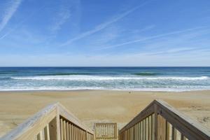 a view of the ocean from a wooden railing on a beach at SO5A - Oceanside Bungalow in Kill Devil Hills