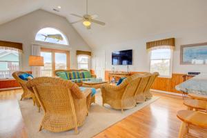 a living room with wicker chairs and a table at 6154 - Little Sushi in Nags Head