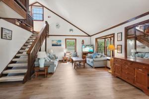 a living room with a staircase in a house at 2029 - Duck Yeah in Duck +52 photos