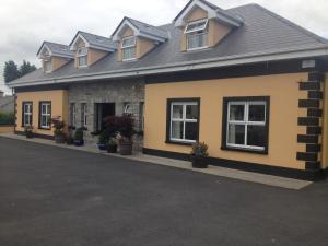 a building with potted plants on the side of it at Carragh House in Castlebar