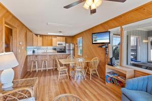 a kitchen and living room with a table and chairs at 7141 - Geri's Place #9 in Wanchese