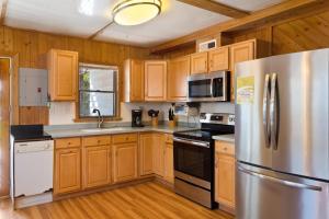 a kitchen with wooden cabinets and a stainless steel refrigerator at 7147 - Geri's Place #11A in Wanchese