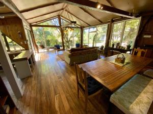 a living room with a wooden table in a house at YerbaBuena Lodge in Monteverde Costa Rica