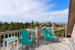 two chairs sitting on the deck of a house at 8074 - Sea Glass Charmer in Avon