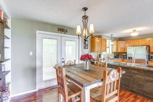 a kitchen with a wooden table and chairs at Treetop Hideaway with Lake Views and Fire Pit! in Fairfield Bay