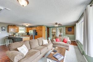 a living room with a couch and a table at Treetop Hideaway with Lake Views and Fire Pit! in Fairfield Bay
