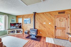 a living room with a woodburning stove in it at Treetop Hideaway with Lake Views and Fire Pit! in Fairfield Bay