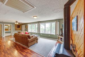 a living room with a couch and a fireplace at Treetop Hideaway with Lake Views and Fire Pit! in Fairfield Bay