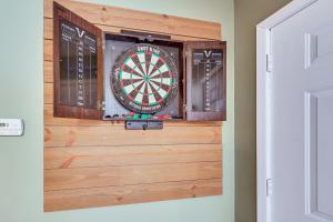 a dart board on a wall in a room at Treetop Hideaway with Lake Views and Fire Pit! in Fairfield Bay