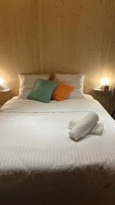 a large white bed with two pillows on it at Bird in Provence - Cabane dans le Luberon in Cavaillon