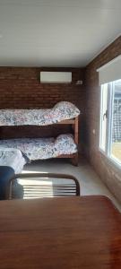 a bedroom with two bunk beds and a window at OMA Departamentos por día -2 in Utracán