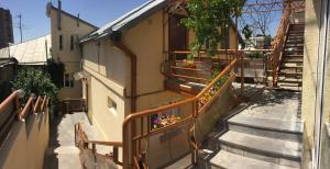 a set of stairs leading to a building with flowers at Tatev Apartments in Yerevan