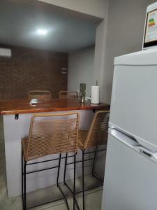 a kitchen with a table and chairs and a refrigerator at OMA Departamentos por día -2 in Utracán