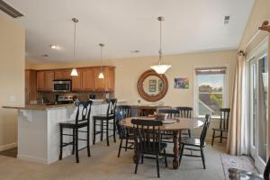 a kitchen and dining room with a table and chairs at CP100A - Sound Sunset in Kill Devil Hills