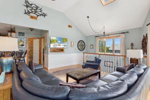 a living room with a couch and a table at 2135 - Pirates Perch in Duck