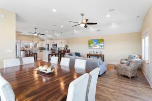 a dining room and living room with a table and chairs at 6299 - Carolina Charm in Nags Head