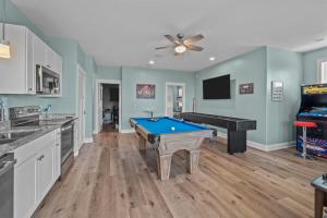 a kitchen with a pool table and a television at 8478 - Seas the Breeze II in Avon +60 photos