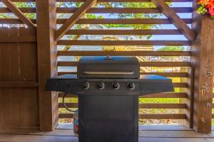 a grill sitting on a patio in a backyard at 5010 - Home Sweet Helga in Avalon Bench