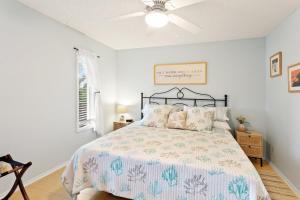 a bedroom with a bed and a ceiling fan at PC3 - Pelican's Hideaway in Avon