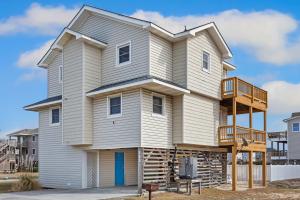 a house with a balcony on top of it at 6001 - Beach Daze in Nags Head +47 photos
