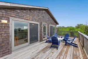 a deck with blue chairs and a table on it at 8205 - Sea La Vie Salvo in Waves +41 photos