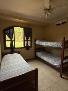 a bedroom with two bunk beds and a ceiling fan at Casaquinta Haras El Tropicano in Bahía Blanca +25 photos