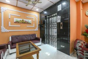 a waiting room with a couch and a table at SPOT ON Hotel River View in Guwahati