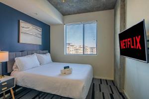 a hotel room with a bed with a sign on the wall at Spacious 2BR Apt with Gym Pool Parking in Phoenix
