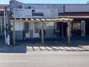 a building with a sign in front of it at Pernoitar in São José