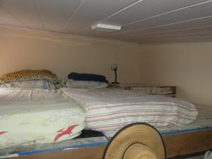 a bedroom with a bed with a cheetah blanket at Tiny House Rio in Rio de Janeiro