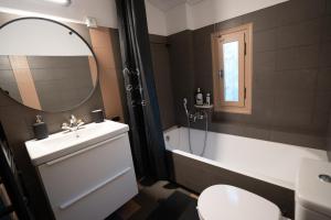 a bathroom with a sink and a tub and a toilet at Το Σπίτι της Γιαγιάς in Paralia Rachon +22 photos