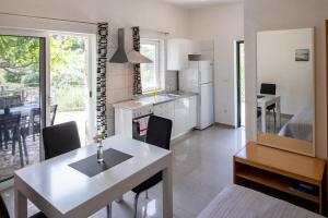 a kitchen with a table and a dining room at Seaside secluded apartments Cove Torac, Hvar - 8653 in Gdinj