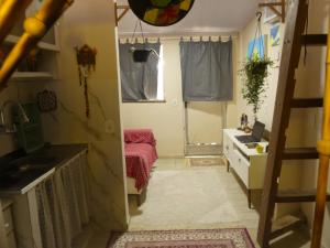 a small room with a sink and a desk at Tiny House Rio in Rio de Janeiro