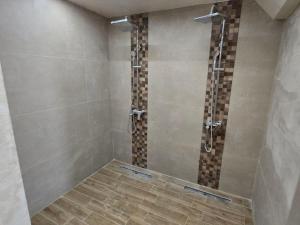 a bathroom with a shower with a glass door at Vila#Borova#800m in Zlatibor