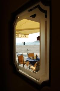 a view of a table and chairs at the beach at Hotel Ca' Formenta in Venice