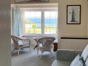 a living room with a view of the ocean at 3 The Coastguards in Downderry