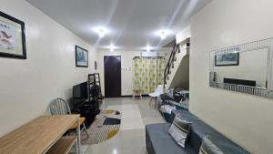 a living room with a couch and a table at Old Home Near Airport in Buaya +11 photos