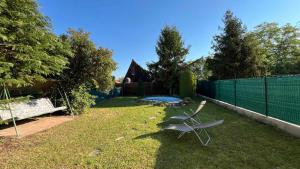 a yard with a chair and a trampoline at Holiday home in Balatonmariafürdo 54665 in Balatonmáriafürdő