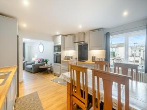 a kitchen and living room with a couch and a table at The Sail Loft in Teignmouth
