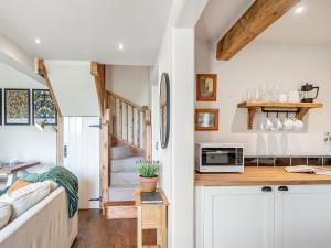 a kitchen and living room in a tiny house at The Hay Loft - Uk45607 in Sigglesthorne +6 photos