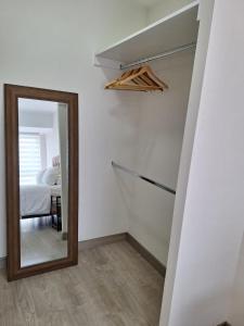 a mirror in a room with a bed and a bedroom at Departamento en San Isidro in Lima
