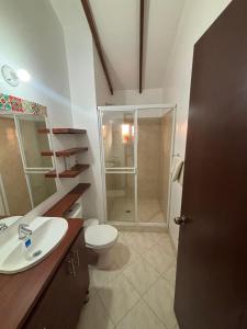 a bathroom with a shower and a toilet and a sink at Casa Bonita in Duitama +5 photos